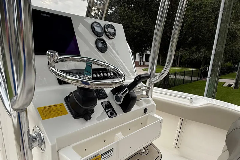 Slide: The Image of 2023 Key West 219 FS boat dashboard with steering wheel and controls. - 5