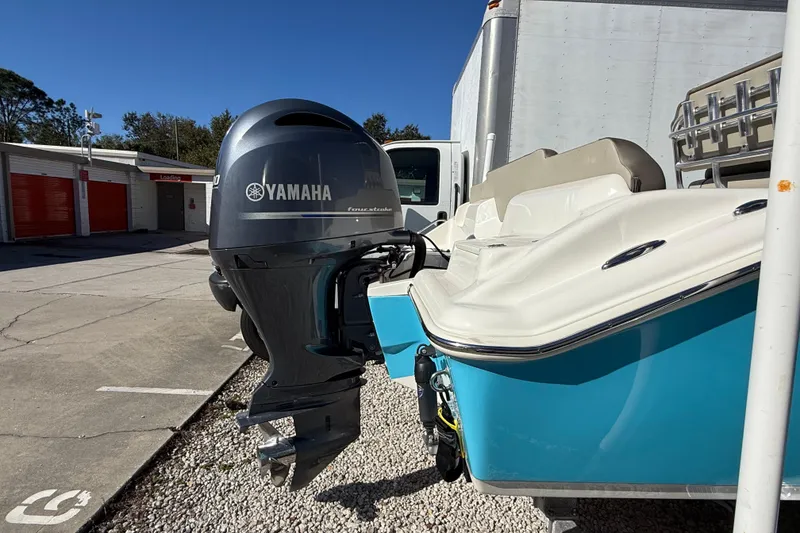 Slide: The Image of 2023 Key West 219 FS boat with Yamaha outboard motor, parked outdoors. - 50