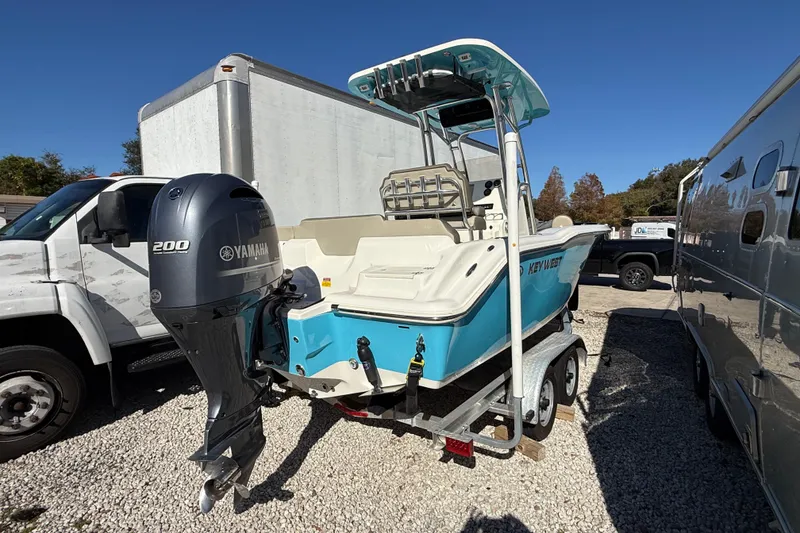 Slide: The Image of 2023 Key West 219 FS boat with Yamaha 200 engine on trailer, parked outdoors. - 51