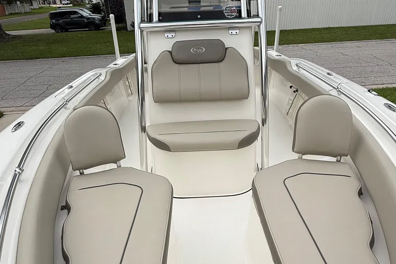 Slide: The Image of 2023 Key West 219 FS boat interior with beige seating and sleek design. - 6