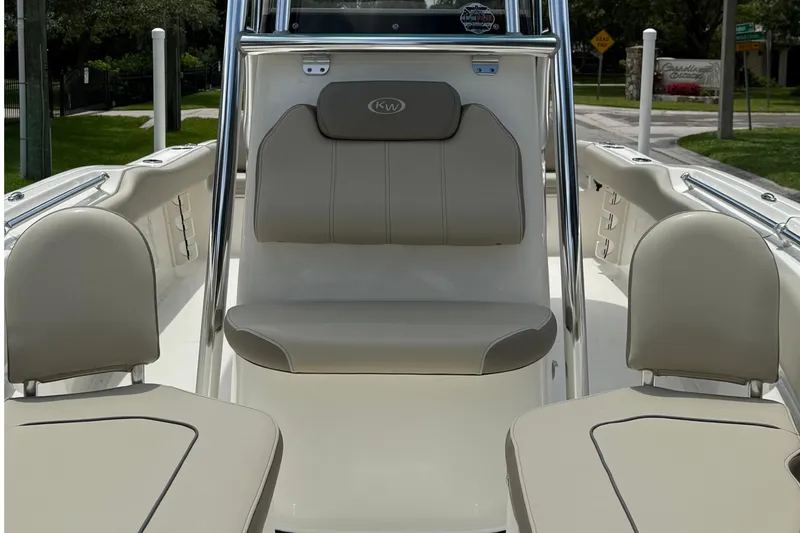 Slide: The Image of 2023 Key West 219 FS boat interior with beige seating and sleek design. - 7