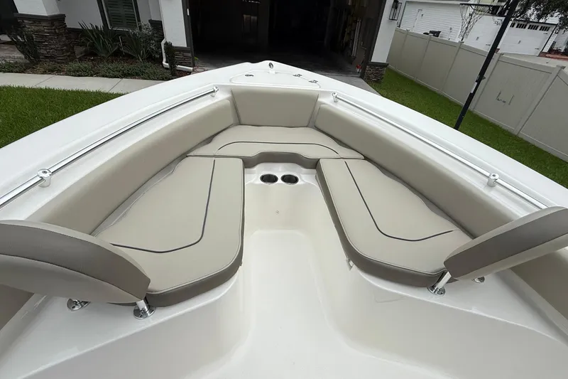 Slide: The Image of 2023 Key West 219 FS boat interior with beige cushioned seating and cup holders. - 8