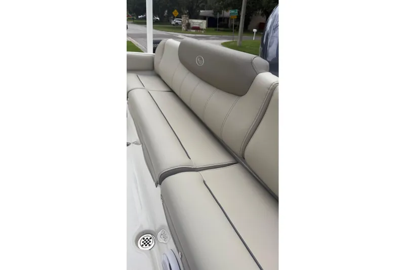 Slide: The Image of 2023 Key West 219 FS boat with beige cushioned seating, outdoor setting. - 9