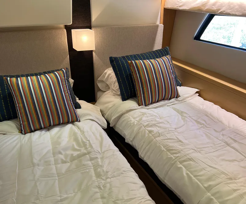 Slide: The Image of Twin beds with striped pillows in a 2013 Prestige 500 S yacht cabin. - 20