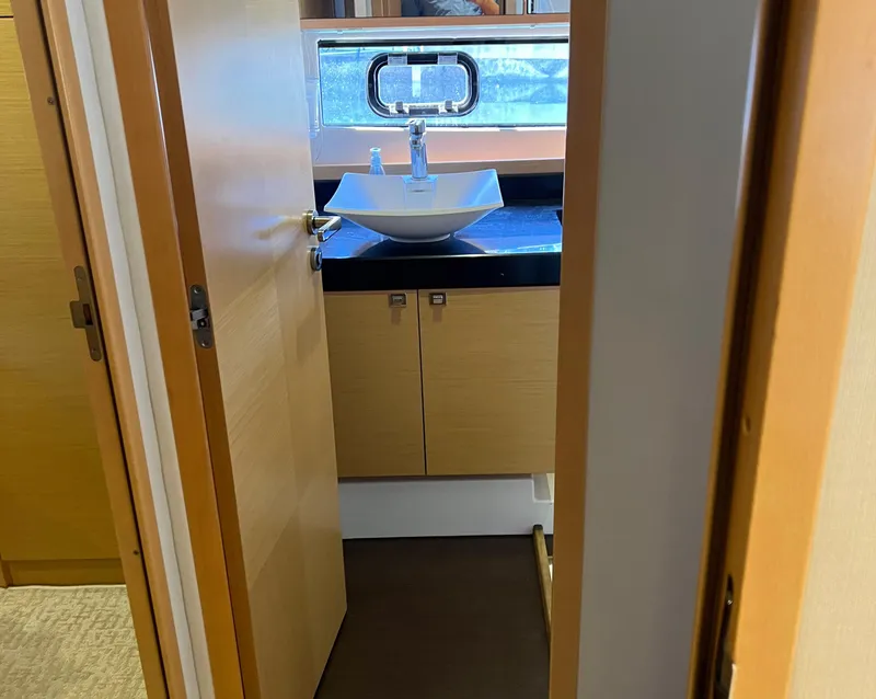 Slide: The Image of Bathroom interior of 2013 Prestige 500 S yacht with modern sink and wooden cabinetry. - 24