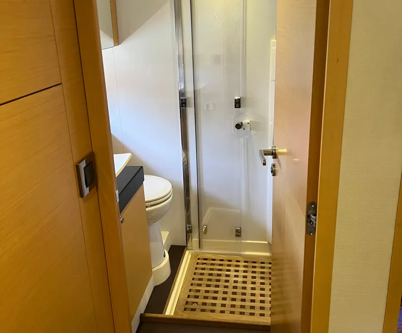 Slide: The Image of Compact bathroom in 2013 Prestige 500 S yacht with shower and wooden accents. - 25