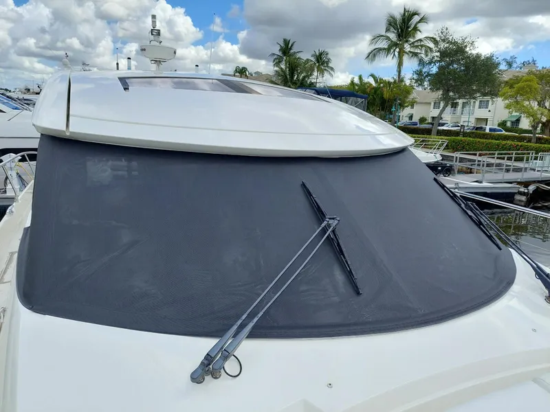 Slide: The Image of 2013 Prestige 500 S yacht with covered windshield and wipers, docked under cloudy skies. - 29