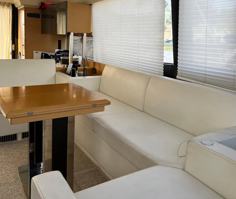 Slide: The Image of Luxurious interior of a 2013 Prestige 500 S yacht with white leather seating and wooden table. - 3