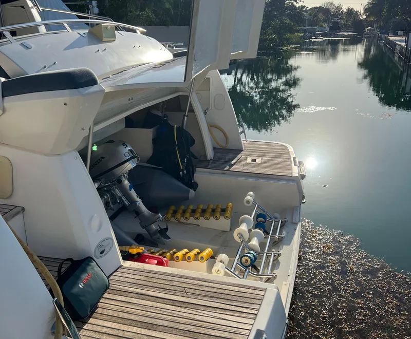 Slide: The Image of 2013 Prestige 500 S yacht with open storage, docked by a serene waterway. - 35