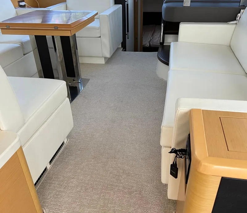 Slide: The Image of Luxurious interior of a 2013 Prestige 500 S yacht with white seating and wooden table. - 5