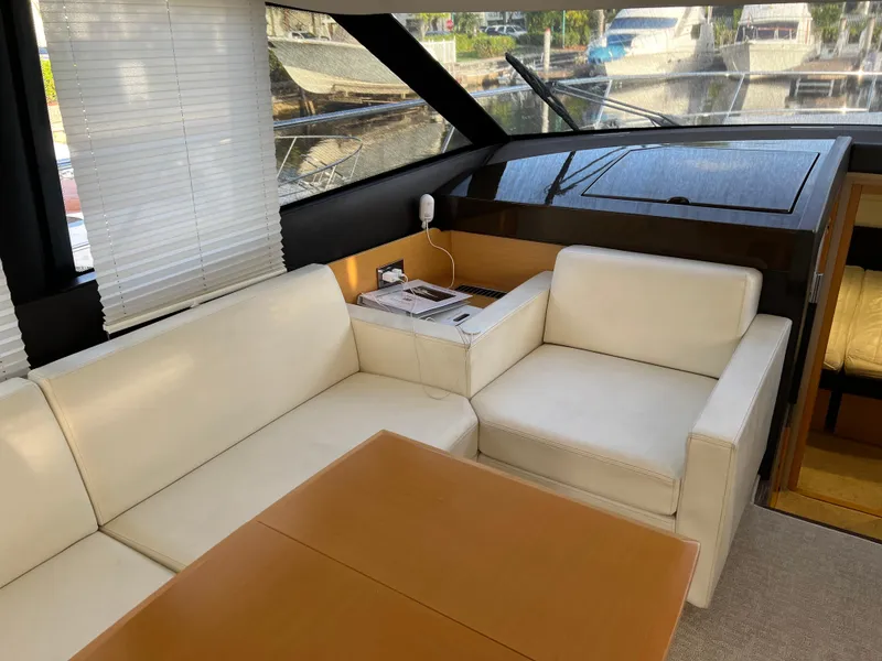 Slide: The Image of Luxurious interior of 2013 Prestige 500 S yacht with white leather seating and wooden table. - 7