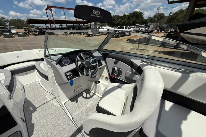 Slide: The Image of 2024 Cobalt 220S boat interior with steering wheel and seating, showcasing luxury design. - 10
