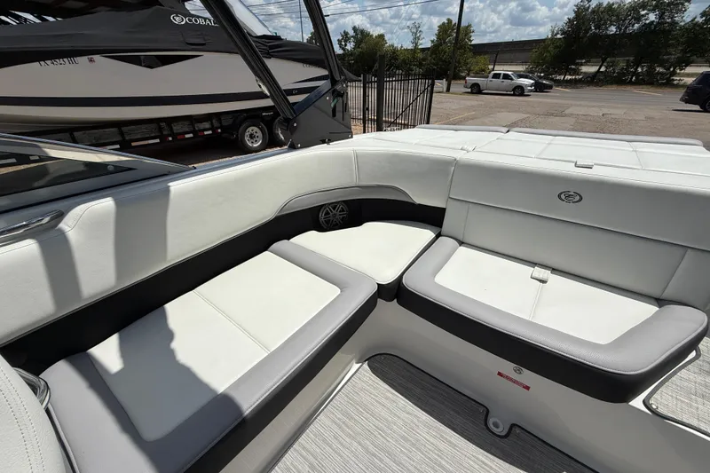 Slide: The Image of 2024 Cobalt 220S boat interior with white and gray seating, showcasing luxury design. - 15