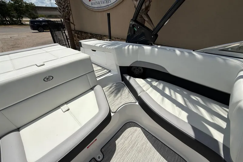 Slide: The Image of 2024 Cobalt 220S boat interior with white seating and modern design. - 16