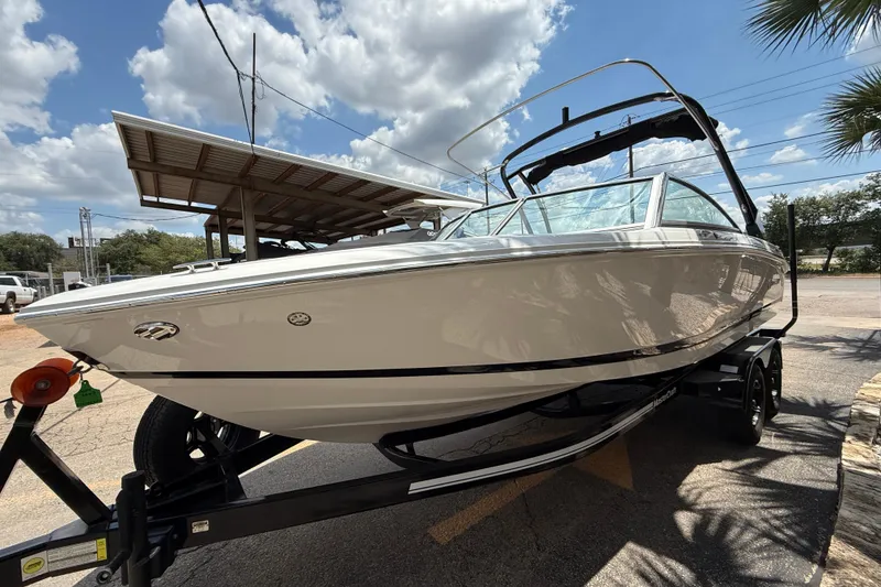 Slide: The Image of 2024 Cobalt 220S boat on trailer under sunny sky, showcasing sleek design. - 3