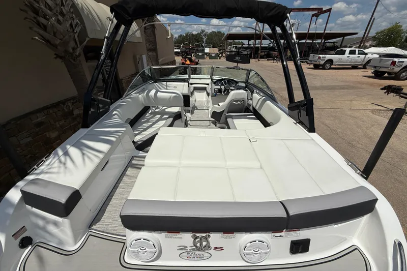 Slide: The Image of 2024 Cobalt 220S boat interior with white seating and sleek design. - 8