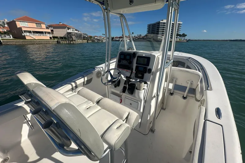 Slide: The Image of 2018 Tidewater 232 LXF boat interior with helm, seats, and waterfront view. - 13
