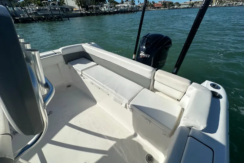 Slide: The Image of 2018 Tidewater 232 LXF boat interior with seating and Yamaha 250 engine on water. - 16
