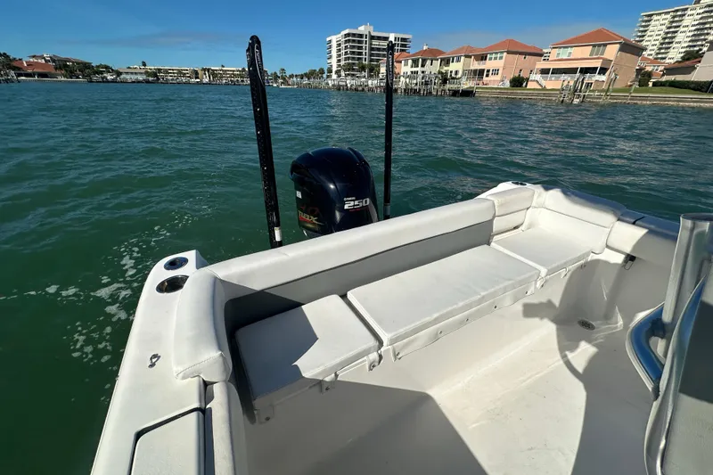 Slide: The Image of 2018 Tidewater 232 LXF boat with Yamaha 250 engine on calm water near waterfront homes. - 18