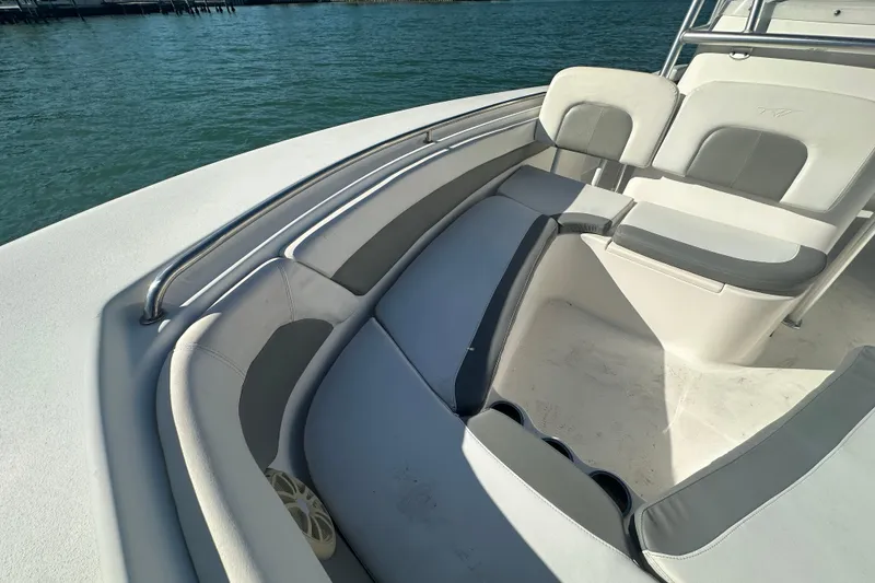 Slide: The Image of 2018 Tidewater 232 LXF boat interior with cushioned seating and stainless steel railings. - 5
