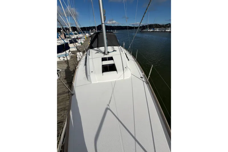 Slide: The Image of 2014 Beneteau 38 sailboat docked at marina, clear sky, calm waters. - 13