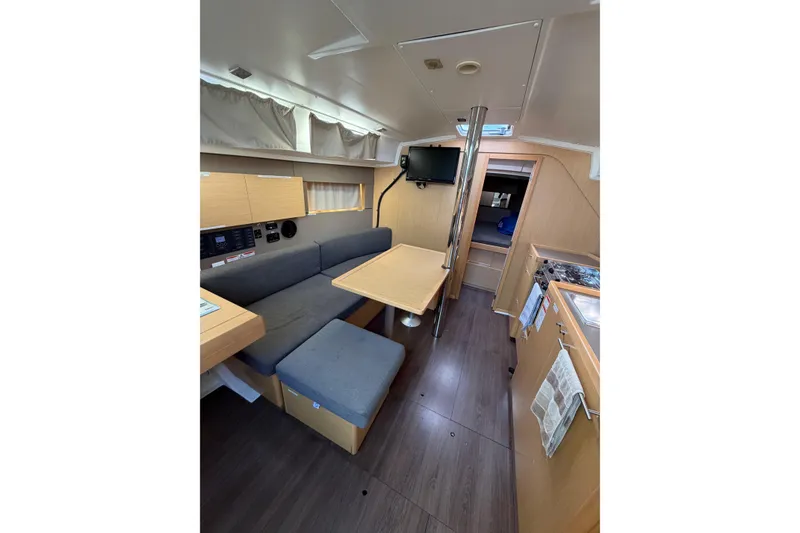 Slide: The Image of Interior of 2014 Beneteau 38 sailboat with cozy seating and modern amenities. - 2