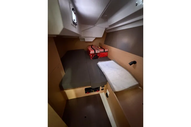Slide: The Image of Interior cabin of 2014 Beneteau 38 sailboat, featuring compact sleeping area and storage. - 8