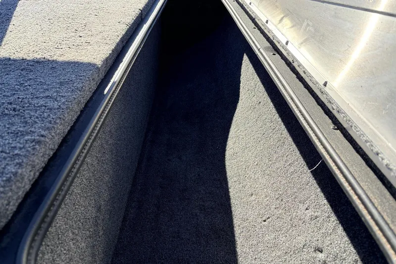 Slide: The Image of 2024 Tracker Pro Team 175 TXW storage compartment with carpeted interior. - 22