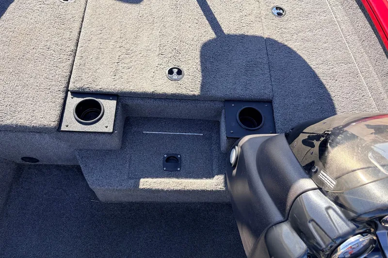 Slide: The Image of 2024 Tracker Pro Team 175 TXW boat interior with carpeted deck and cup holders. - 23