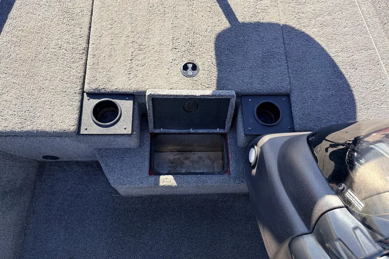 Slide: The Image of 2024 Tracker Pro Team 175 TXW boat interior with storage compartments and cup holders. - 24