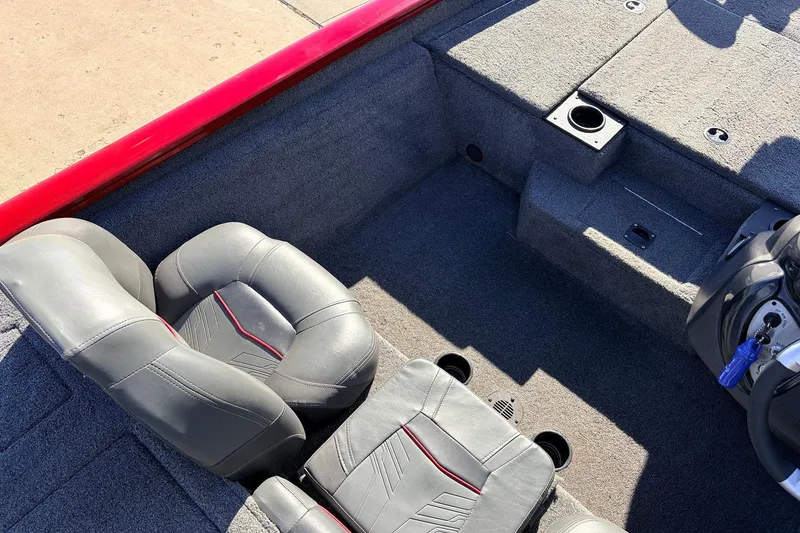 Slide: The Image of 2024 Tracker Pro Team 175 TXW boat interior with gray seats and red accents. - 27