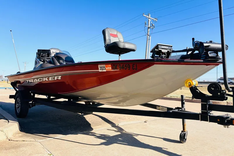 Slide: The Image of 2024 Tracker Pro Team 175 TXW boat on trailer, red and white design, parked outdoors. - 3
