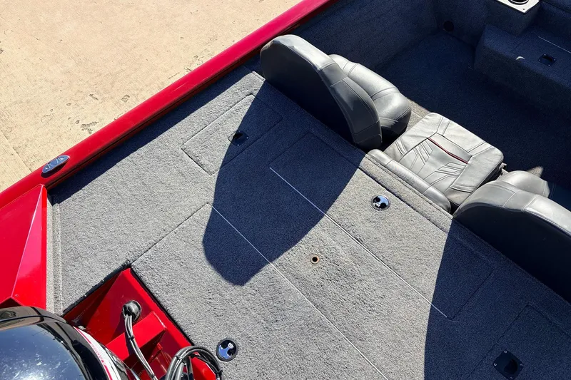 Slide: The Image of 2024 Tracker Pro Team 175 TXW boat interior with gray carpet and seating. - 34