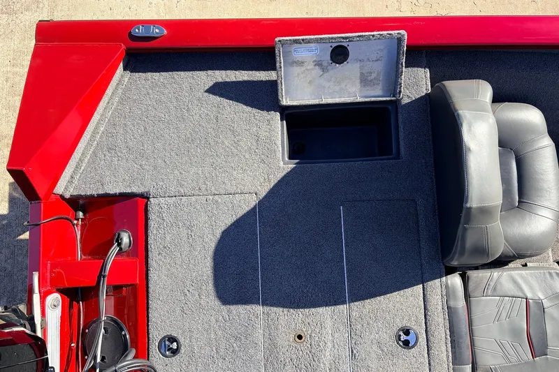 Slide: The Image of 2024 Tracker Pro Team 175 TXW boat interior with red accents and seating. - 36