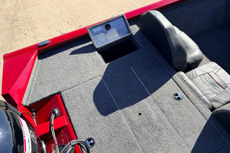 Slide: The Image of 2024 Tracker Pro Team 175 TXW boat interior with gray carpet and seating. - 37
