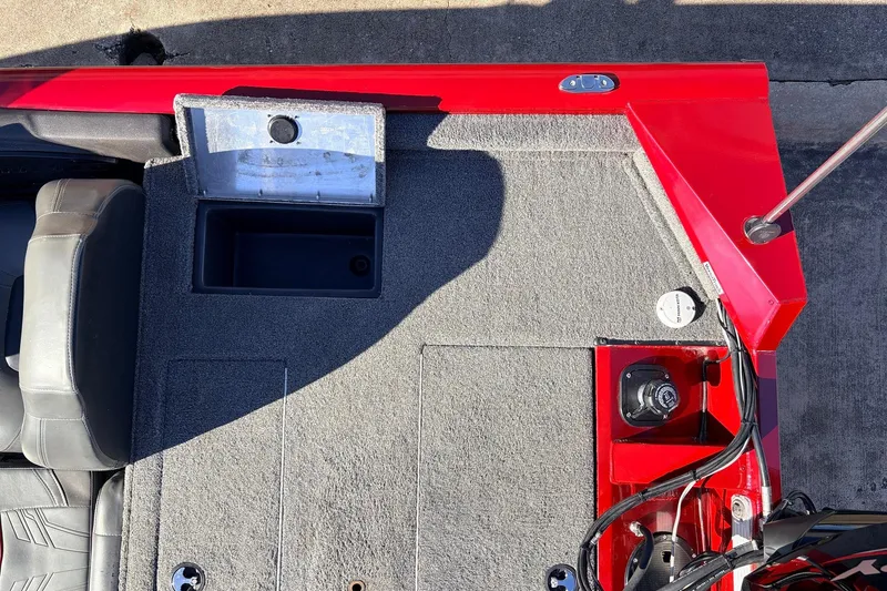 Slide: The Image of 2024 Tracker Pro Team 175 TXW boat interior with red accents and storage compartments. - 38