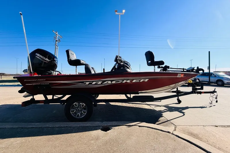 Slide: The Image of 2024 Tracker Pro Team 175 TXW boat on trailer, side view, outdoors. - 4