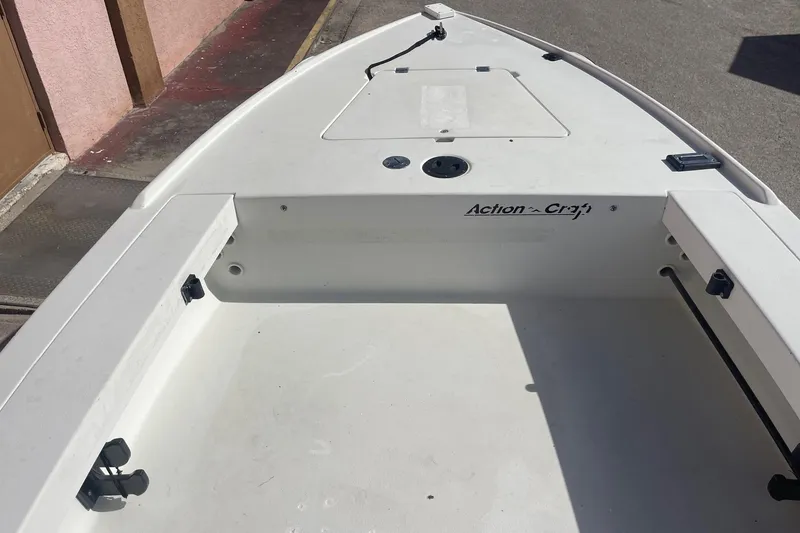 Slide: The Image of 2002 Action Craft 1802 boat interior, showing spacious deck and storage compartments. - 11