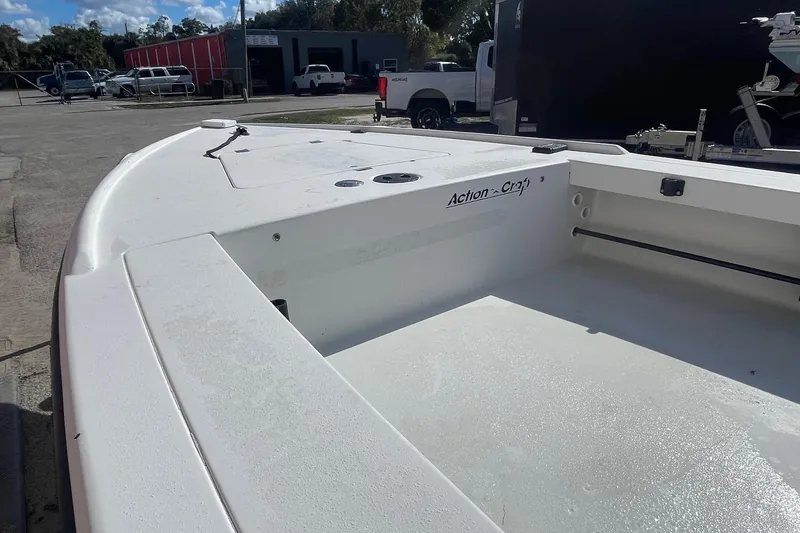 Slide: The Image of 2002 Action Craft 1802 boat, white deck, parked outdoors near vehicles and buildings. - 5