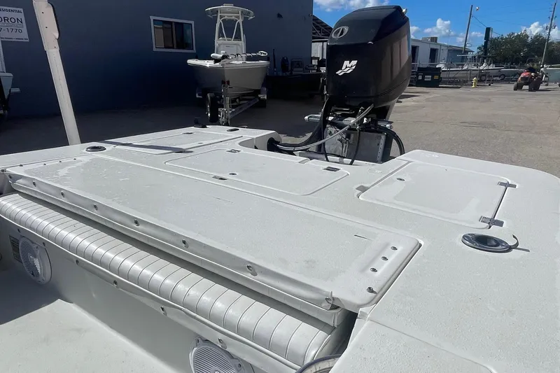 Slide: The Image of 2002 Action Craft 1802 boat with outboard motor in a marina setting. - 6