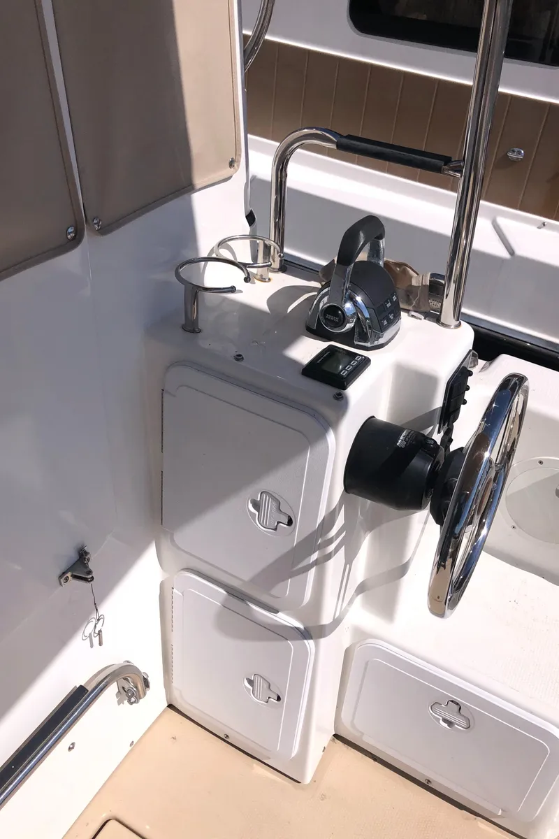 Slide: The Image of 2016 Cutwater 30 Command Bridge helm with steering wheel and controls. - 10