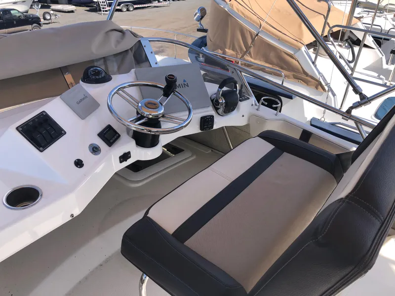 Slide: The Image of 2016 Cutwater 30 Command Bridge helm with steering wheel and control panel. - 15