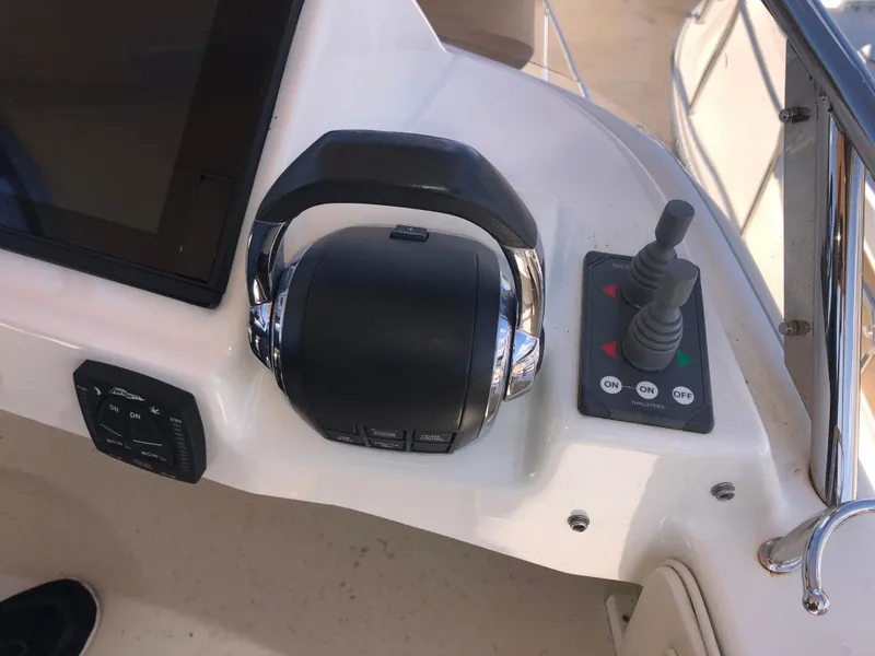 Slide: The Image of Control panel of 2016 Cutwater 30 Command Bridge boat with throttle and joystick. - 18