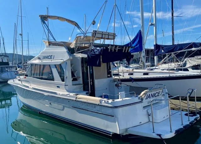 Slide: The Image of 2016 Cutwater 30 Command Bridge boat docked in marina, sunny day. - 2
