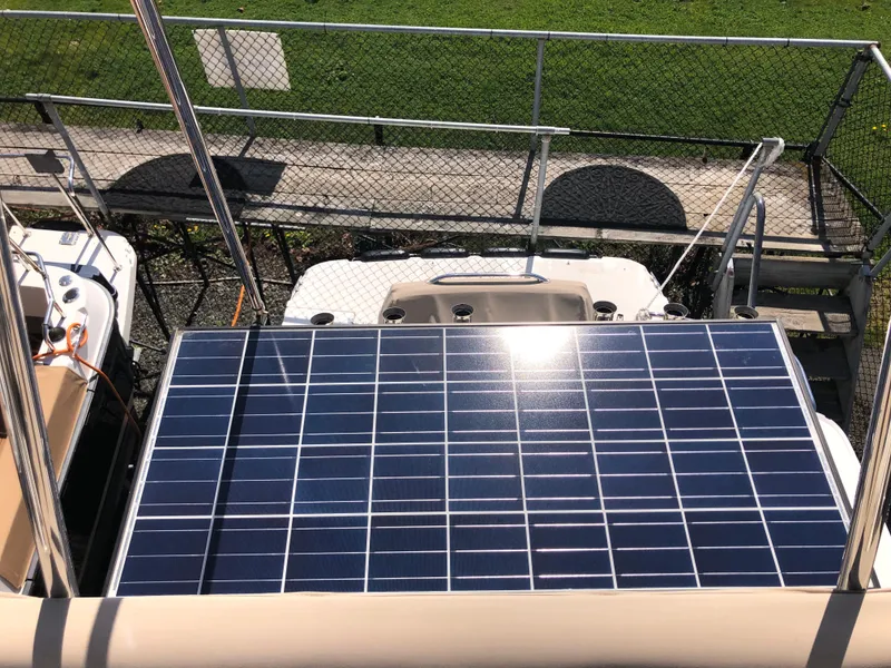 Slide: The Image of Solar panel on 2016 Cutwater 30 Command Bridge boat, docked near green lawn. - 22