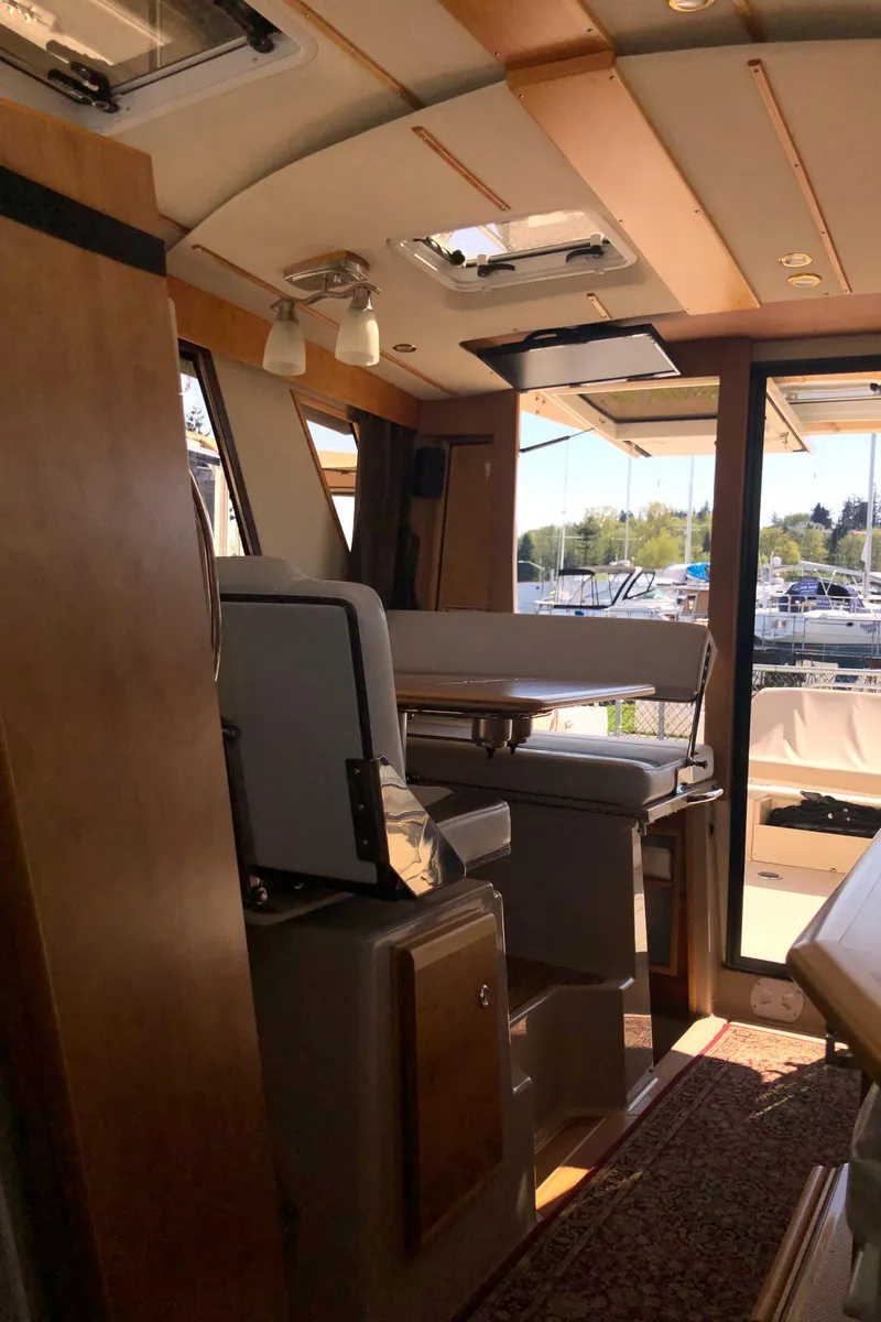 Slide: The Image of Interior of 2016 Cutwater 30 Command Bridge, featuring wood accents and seating area. - 23