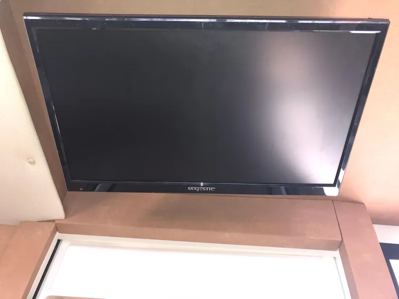 Slide: The Image of Flat-screen TV mounted inside 2016 Cutwater 30 Command Bridge boat. - 24