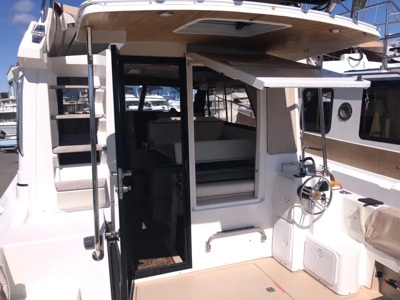 Slide: The Image of 2016 Cutwater 30 Command Bridge boat with open cabin and helm, docked at marina. - 26