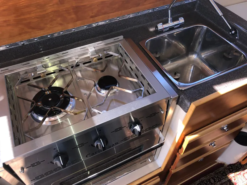 Slide: The Image of 2016 Cutwater 30 Command Bridge kitchen with stove and sink. - 29