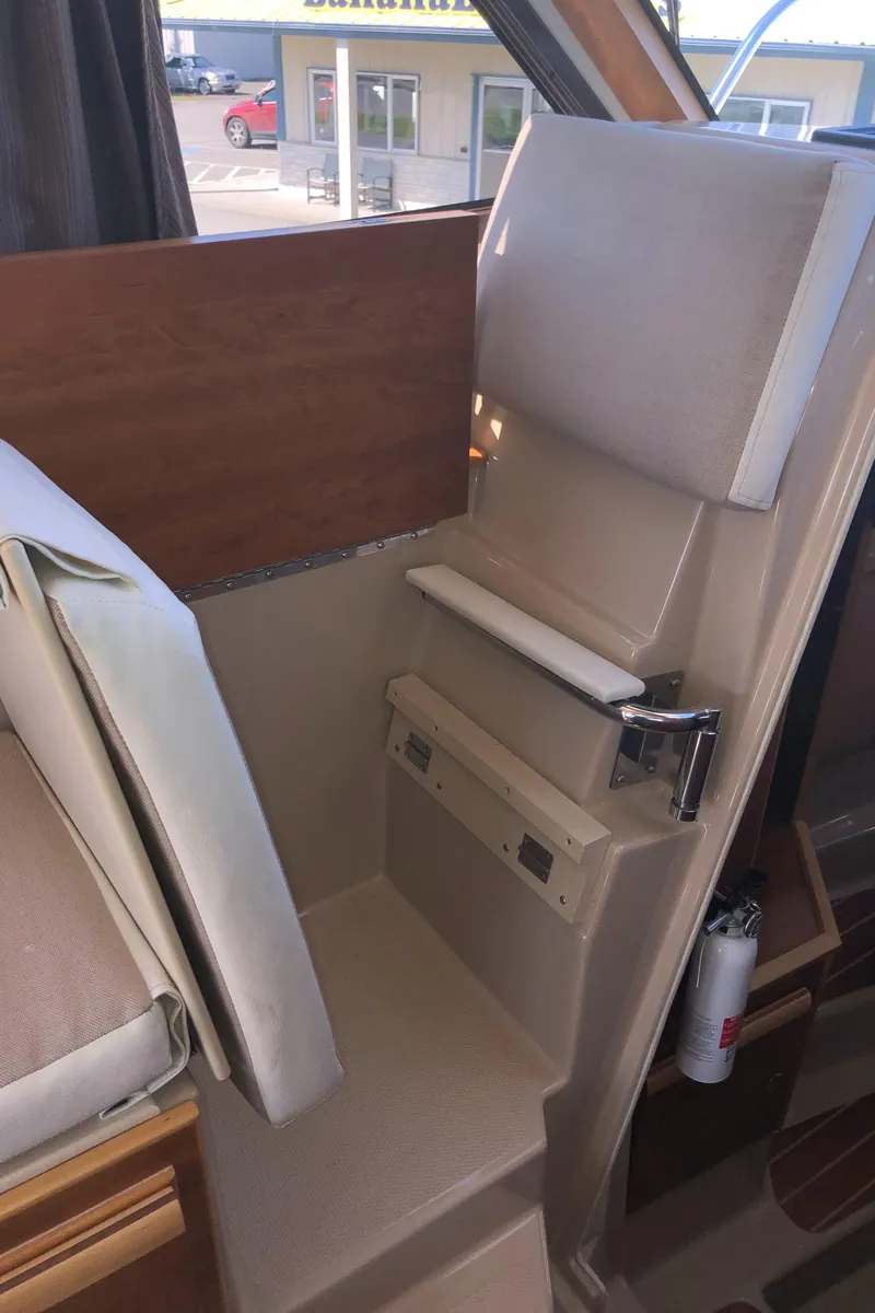 Slide: The Image of 2016 Cutwater 30 Command Bridge interior seating area with beige upholstery. - 36